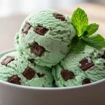 Creamy keto mint chocolate chip ice cream scoops with fresh mint garnish