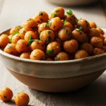 Golden crispy air fryer chickpeas in a rustic bowl, seasoned with smoked paprika and herbs