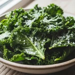 Crunchy paleo kale chips in a bowl, baked until crispy and lightly seasoned